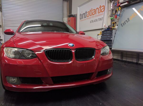 Red BMW Coupe front view with dark window tint by tintsaltlake